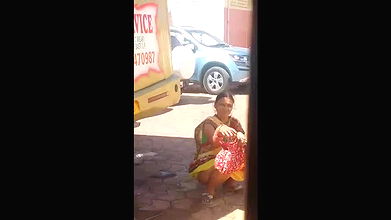 Indian Ladies peeing behind bus
