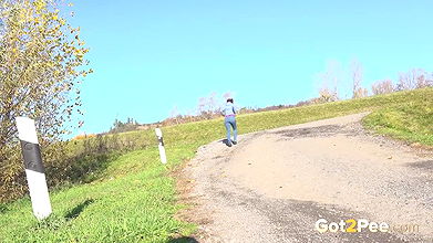 Antonia Sainz holds her pussy and pees outside