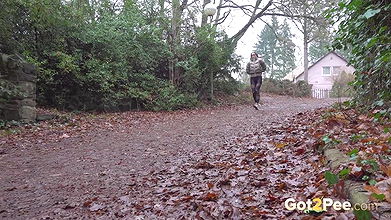 Barbe squats and pees on the ground in the rain