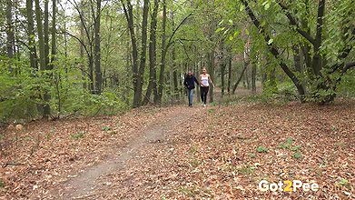 Best friends piss on the ground in the woods