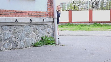 Blonde babe pisses outside in the city