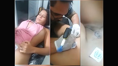 Cute chubby girl having tattoo on pussy