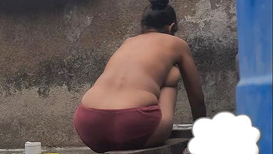 Desi Indian village bathroom in open courtyard wearing red tights bathing