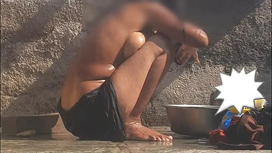 The stepsister is bathing naked in an open bathroom in the village