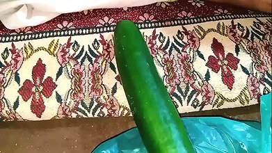 Aunty drains the water from the cucumber while relishing the cucumber to the fullest