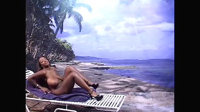 Sweet black babe gets naked by the ocean