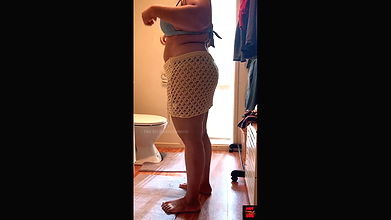 Dressing up in sexy and stylish bikini in the bathroom