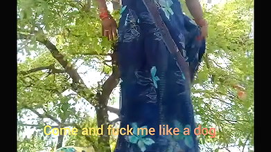 Asking pleasure outdoor in the farm sitting wearing saree