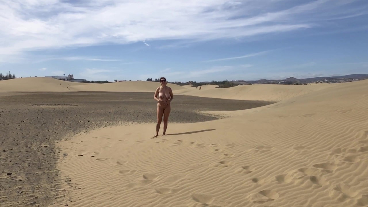 Wild beach. Nudist beach. Exhibitionists. Sexy naked girl sunbathing. Public nudity. Naked in public_7400d18f