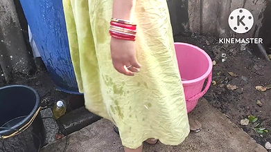 indian housewife bathing outside with dance
